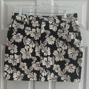 Motel | NWT denim style mini skirt with white florals; front zipper and pockets